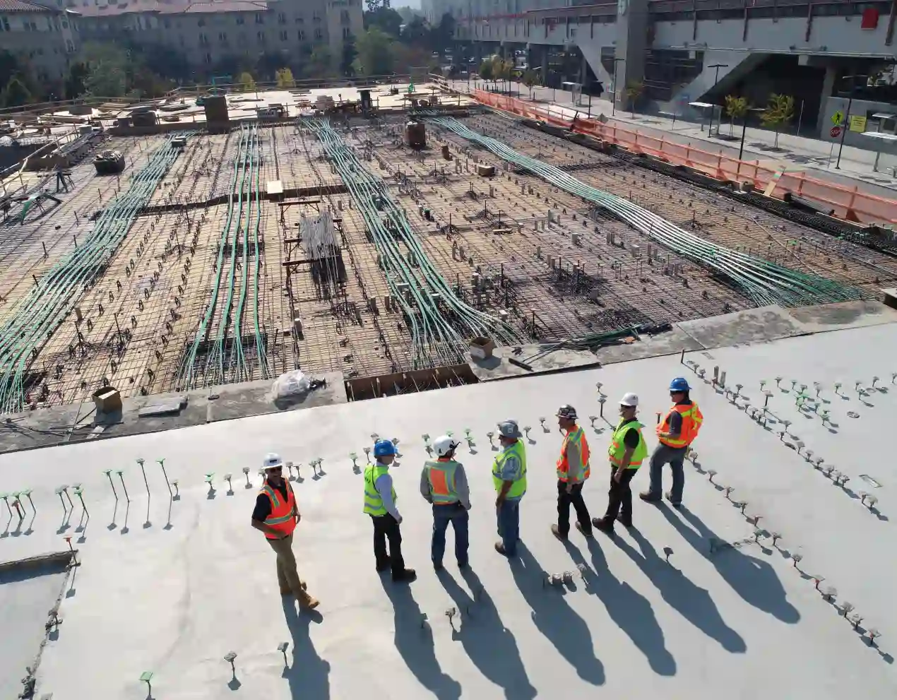 a construction site with workers wearing reflective vests