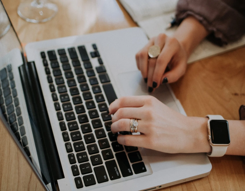 a woman on a laptop writing a blog article